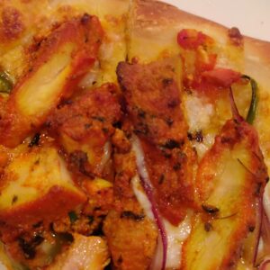 Tikka Pizza -with Red Basil Sauce Tandoori Chicken (Halal) Red Onion, Green Pepper, Tomato Cheese, Jalapeño, Cilantro