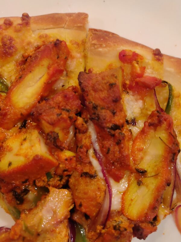 Tikka Pizza -with Red Basil Sauce Tandoori Chicken (Halal) Red Onion, Green Pepper, Tomato Cheese, Jalapeño, Cilantro