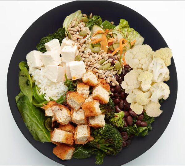 Plant Based Vegan Plant-based tenders, cucumber namasu, roasted cauliflower, roasted broccoli, black beans, firm tofu, seed blend, your choice of grains with our greens blend and Sesame Dressing (served on side).